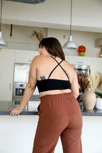 Load image into Gallery viewer, Crochet lace black bralette halter style with secure cross-back.