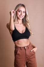 Load image into Gallery viewer, Feminine seamless black bralette with racerback fit and soft lace trim.