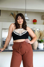 Load image into Gallery viewer, High-neck crochet black bralette with a lightweight and stretchy fit.

